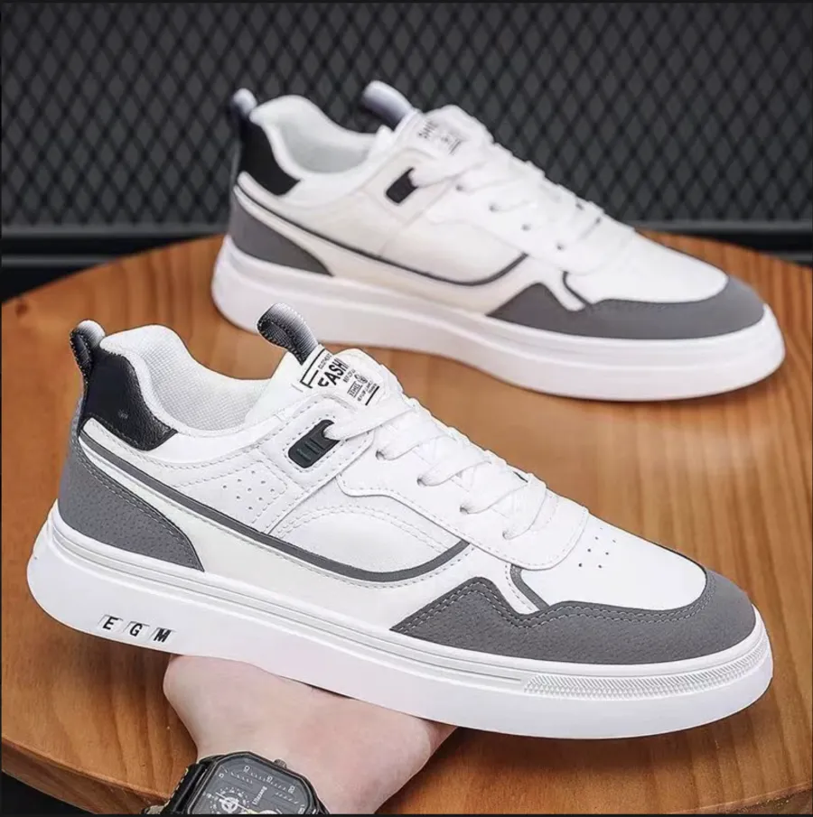 A casual photo of a pair of white sneakers held in hand